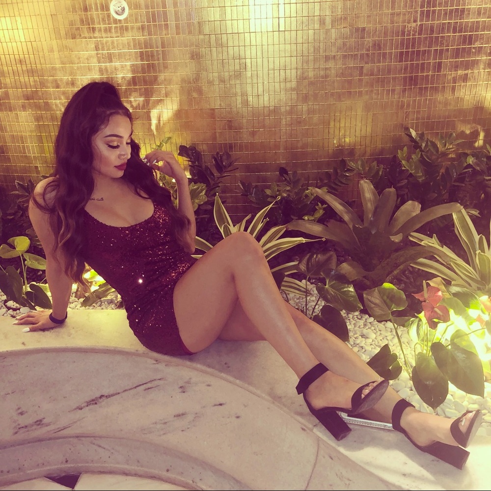 A hot burgundy sparkly mini dress perfect for a party or vagaries.